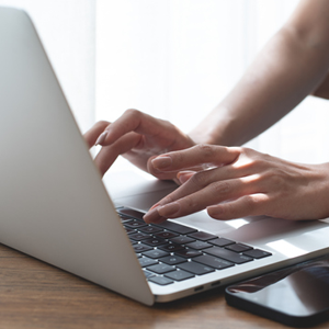 Woman typing on laptop computer